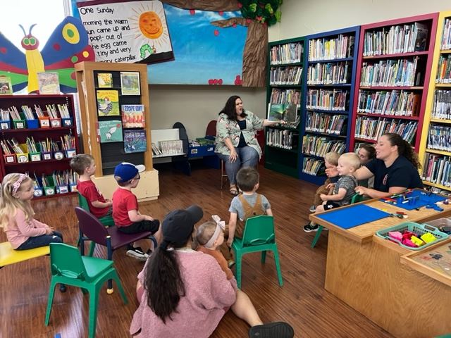 Children splattering colorful paint on a canvas