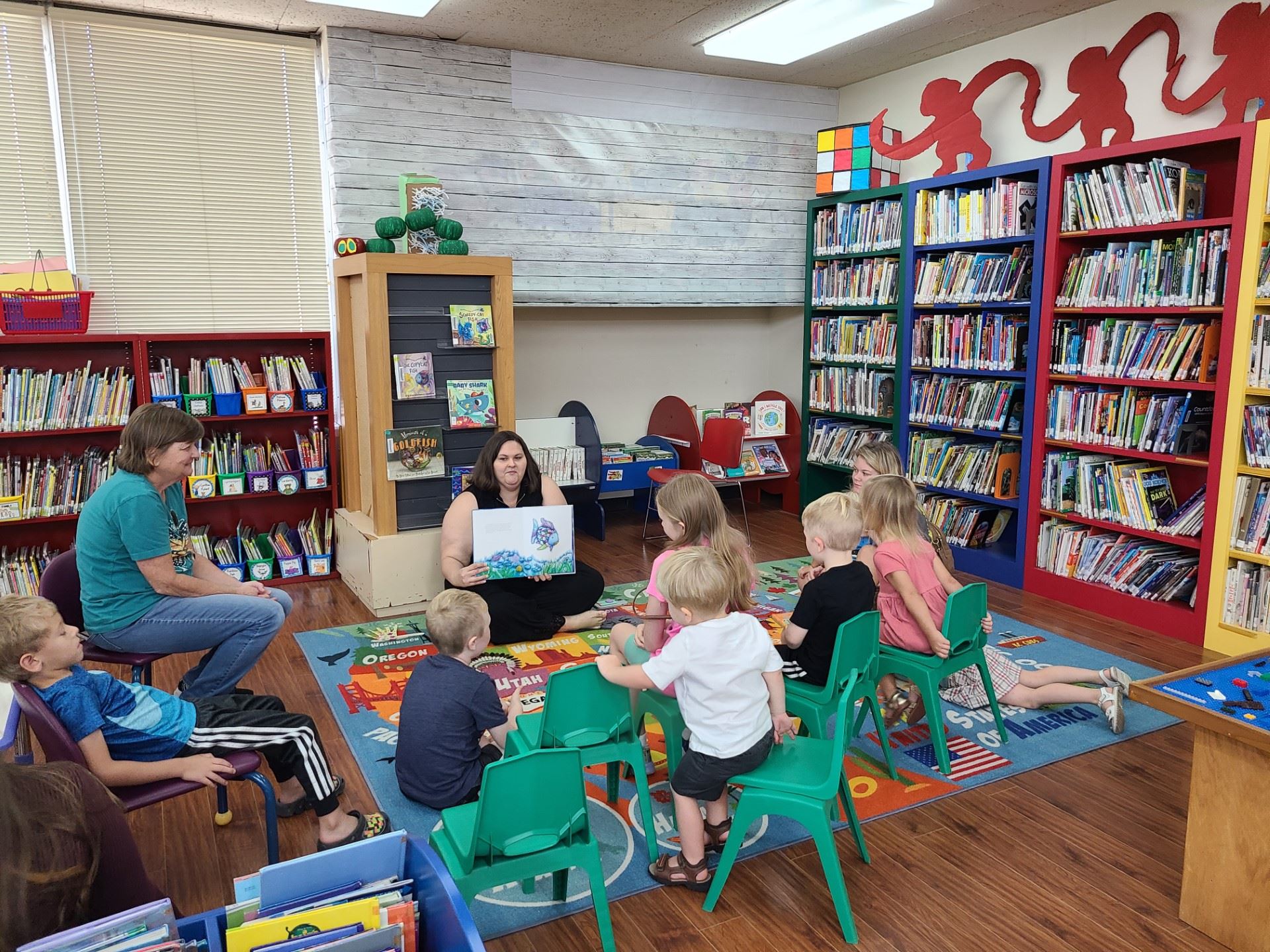 Ms. Sarah reading to young children